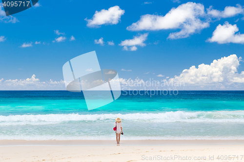 Image of Woman enjoying picture perfect beach on Mahe Island, Seychelles.