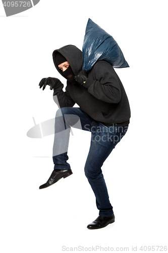 Image of Robber sneaks in black mask