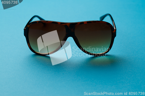 Image of Sunglasses on blank blue background