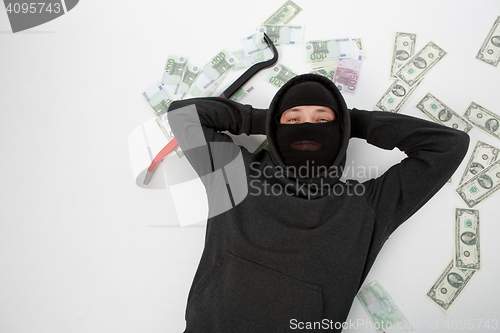 Image of Satisfied burglar lies on floor