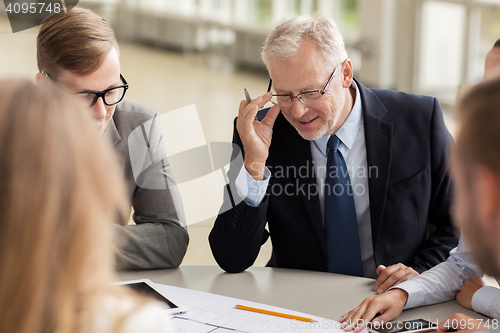 Image of architects with tablet pc and blueprint at office