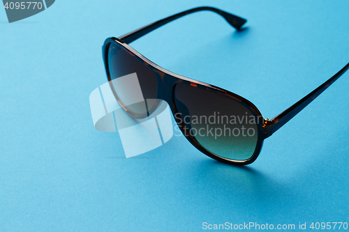 Image of Sunglasses on empty blue background