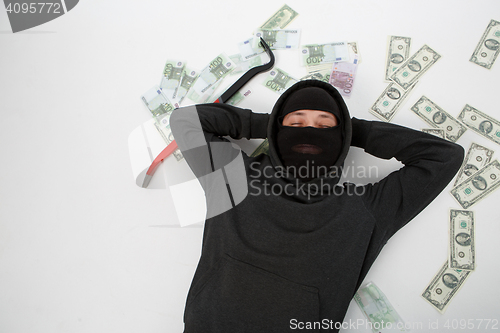 Image of Robber on floor with money