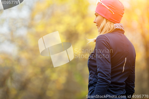 Image of Girl standing back in forest