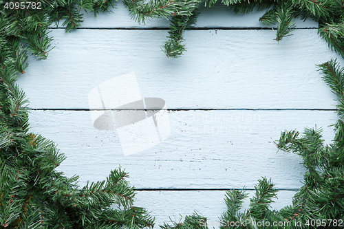 Image of Christmas and new year blue wooden background with fir tree