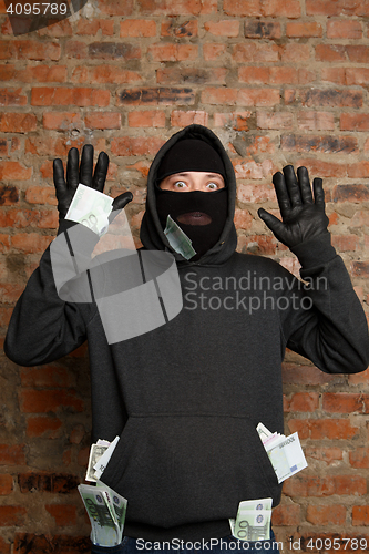 Image of Robber with banknotes in pockets
