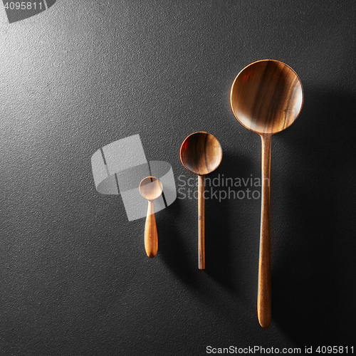 Image of Wood spoons on black board background