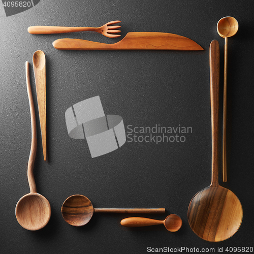 Image of frame of wooden spoons, forks and a knife