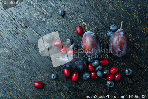 Image of Fresh plums on a dark wooden table