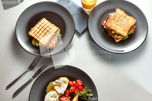 Image of Traditional breakfast of sandwiches and juice