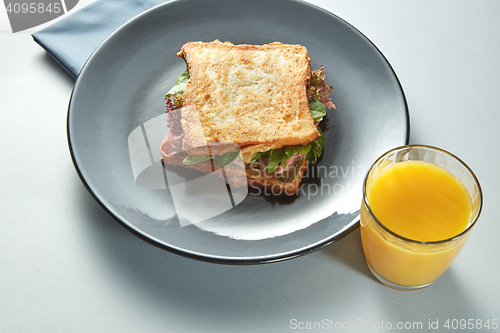 Image of plate with grilled sandwich and orange juice