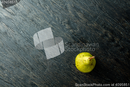 Image of one juicy and ripe pear on a black background.