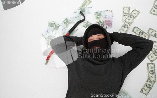 Image of Burglar lying with passkey , money