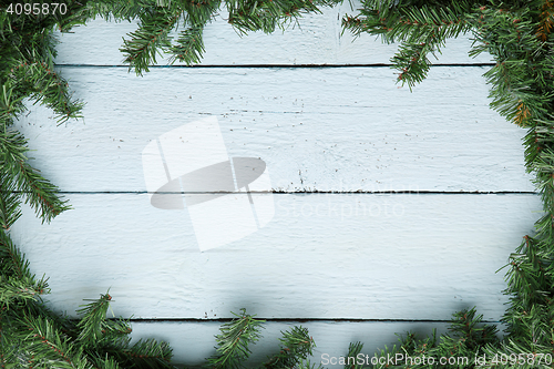 Image of Wooden board with fir branches. Christmas and new year background