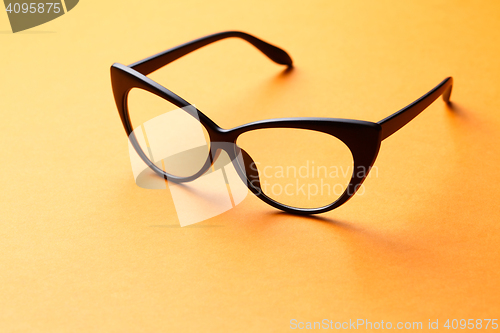 Image of Brown glasses on orange background