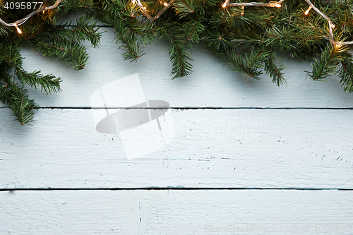 Image of Christmas, new year wooden background with fir tree and garland