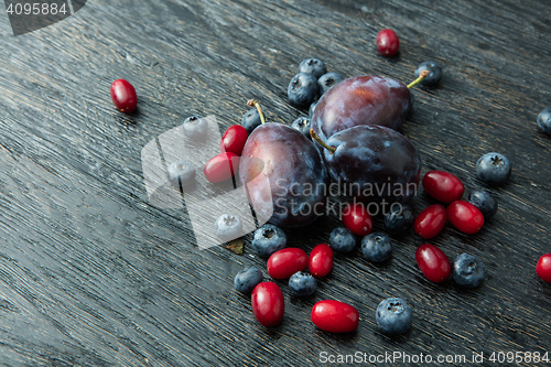 Image of Fresh plums on a dark wooden table