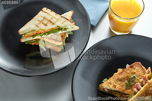 Image of delicious breakfast sandwiches and orange juice