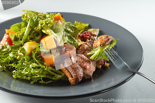 Image of salad with pumpkin on white background