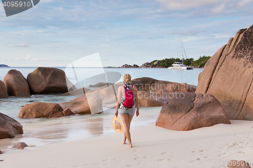 Image of Woman enjoying Anse Lazio picture perfect beach on Praslin Island, Seychelles.