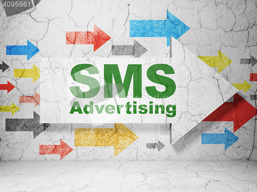 Image of Advertising concept: arrow with SMS Advertising on grunge wall background