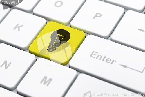 Image of Finance concept: Light Bulb on computer keyboard background