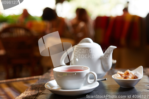Image of white teapot with tea Cup, saucer and teaspoon
