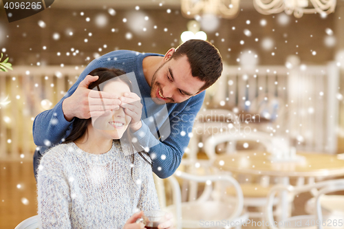 Image of happy couple drinking tea at cafe