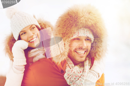 Image of happy couple having fun over winter background