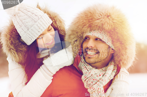 Image of happy couple having fun over winter background