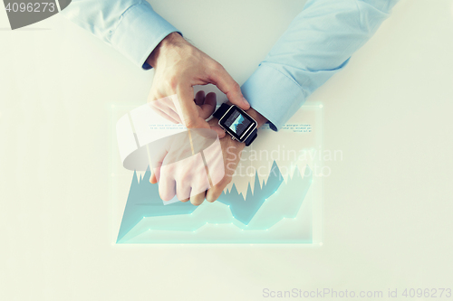 Image of hand with smartwatch and virtual chart projection