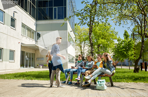 Image of teenage students with tablet pc at school yard