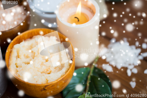 Image of natural body scrub and candle on wood