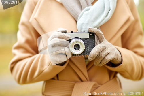 Image of close up of woman with camera in autumn park