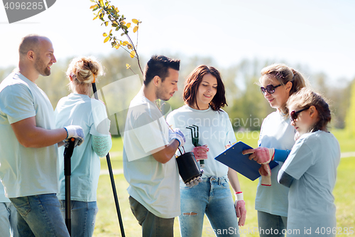 Image of group of volunteers planting trees in park