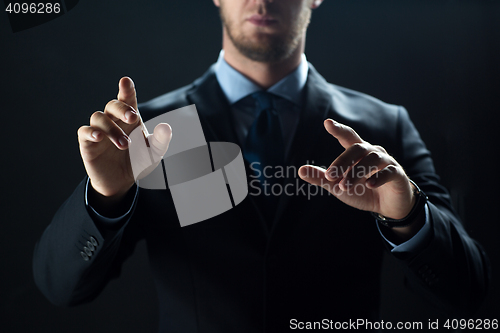 Image of close up of businessman touching virtual screen