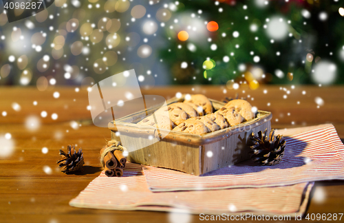 Image of close up of christmas oat cookies on wooden table