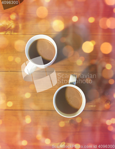 Image of cups of hot chocolate or cocoa drinks on wood