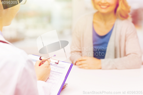 Image of close up of doctor and woman meeting at hospital