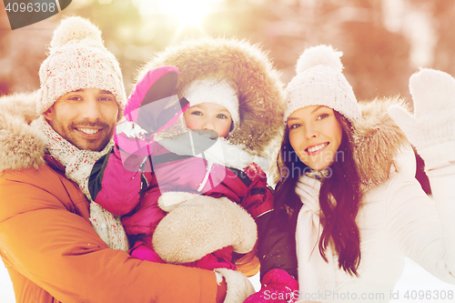 Image of happy family waving hands outdoors in winter