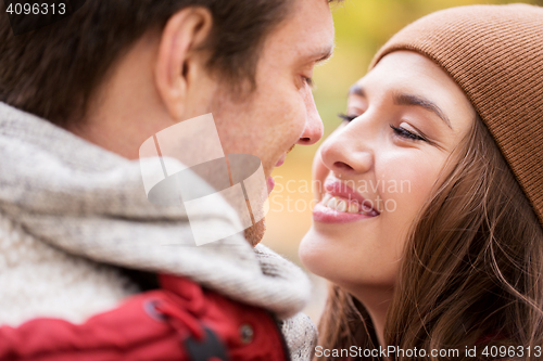 Image of close up of happy young couple kissing outdoors