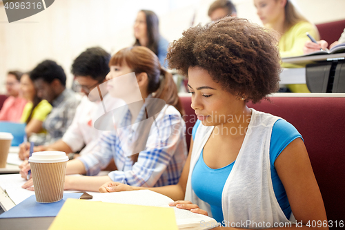 Image of group of students with coffee writing on lecture