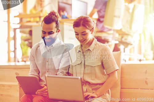 Image of creative team with tablet pc and laptop in office