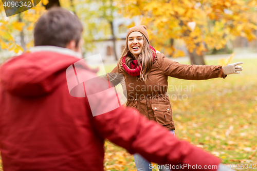 Image of happy young couple meeting in autumn park