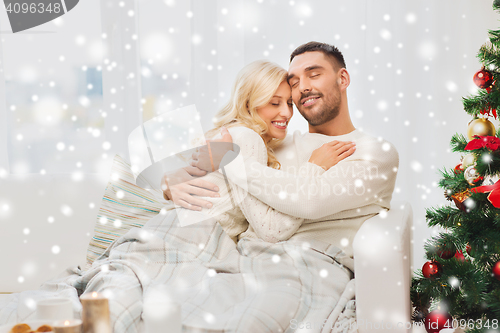 Image of happy couple at home with christmas tree