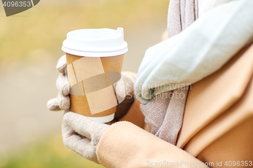 Image of close up of woman with coffee in autumn park