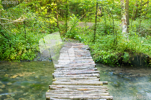 Image of Homemade wooden bridge over a small river forest