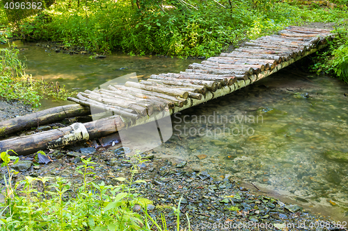 Image of Wooden bridge over a small river forest