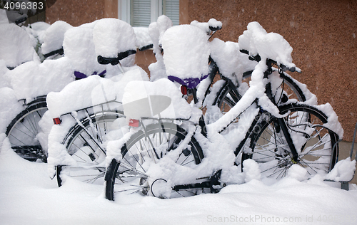 Image of Snow covered Bikes in a Stockholm street