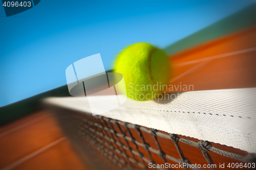 Image of Tennis ball hitting the net